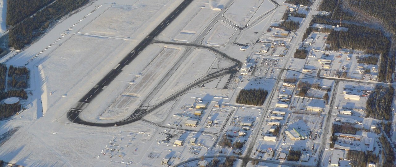 The city of Kenai, Alaska from the air in winter, with the airport and downtown